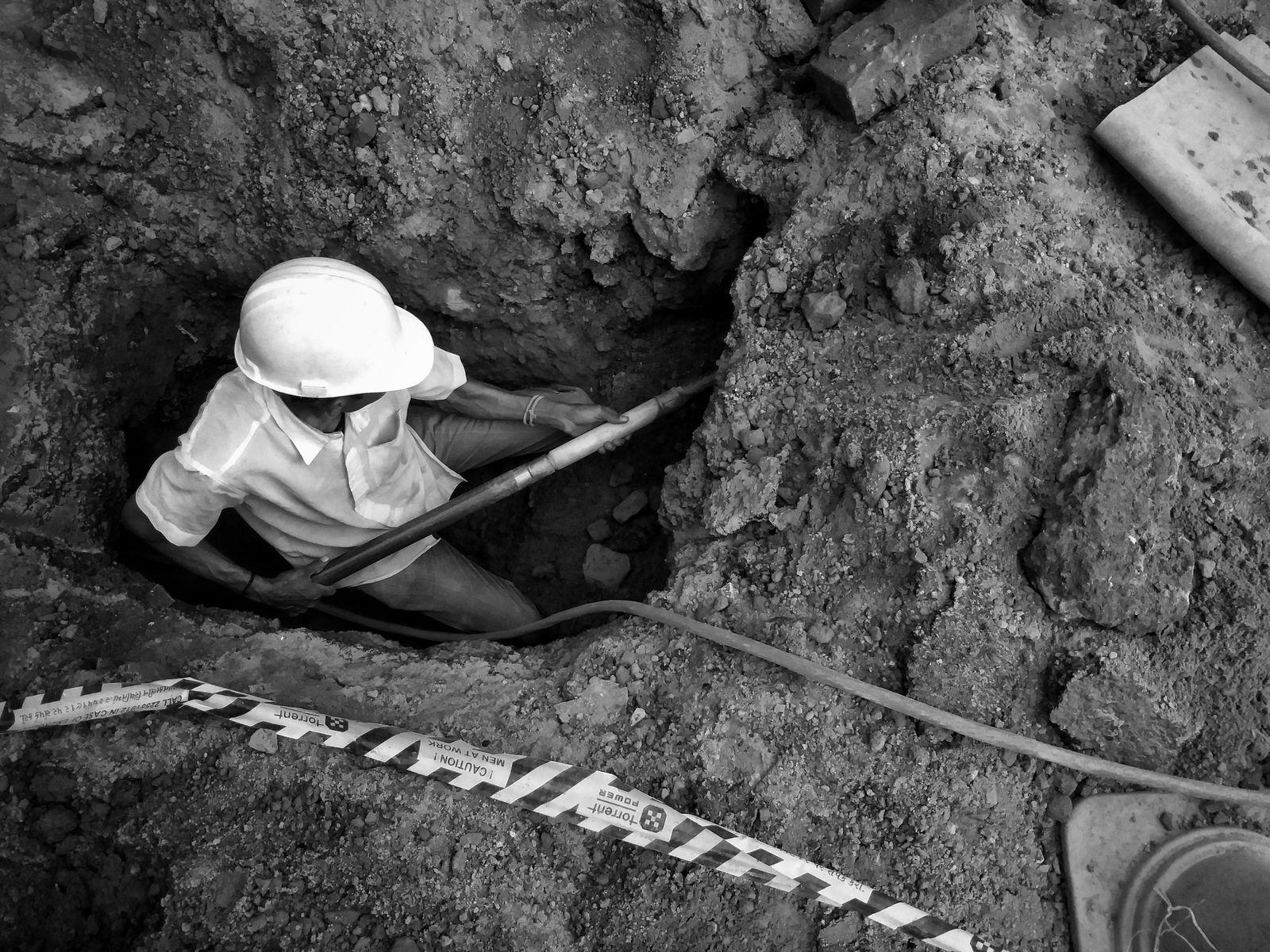 Worker in a trench at a construction site