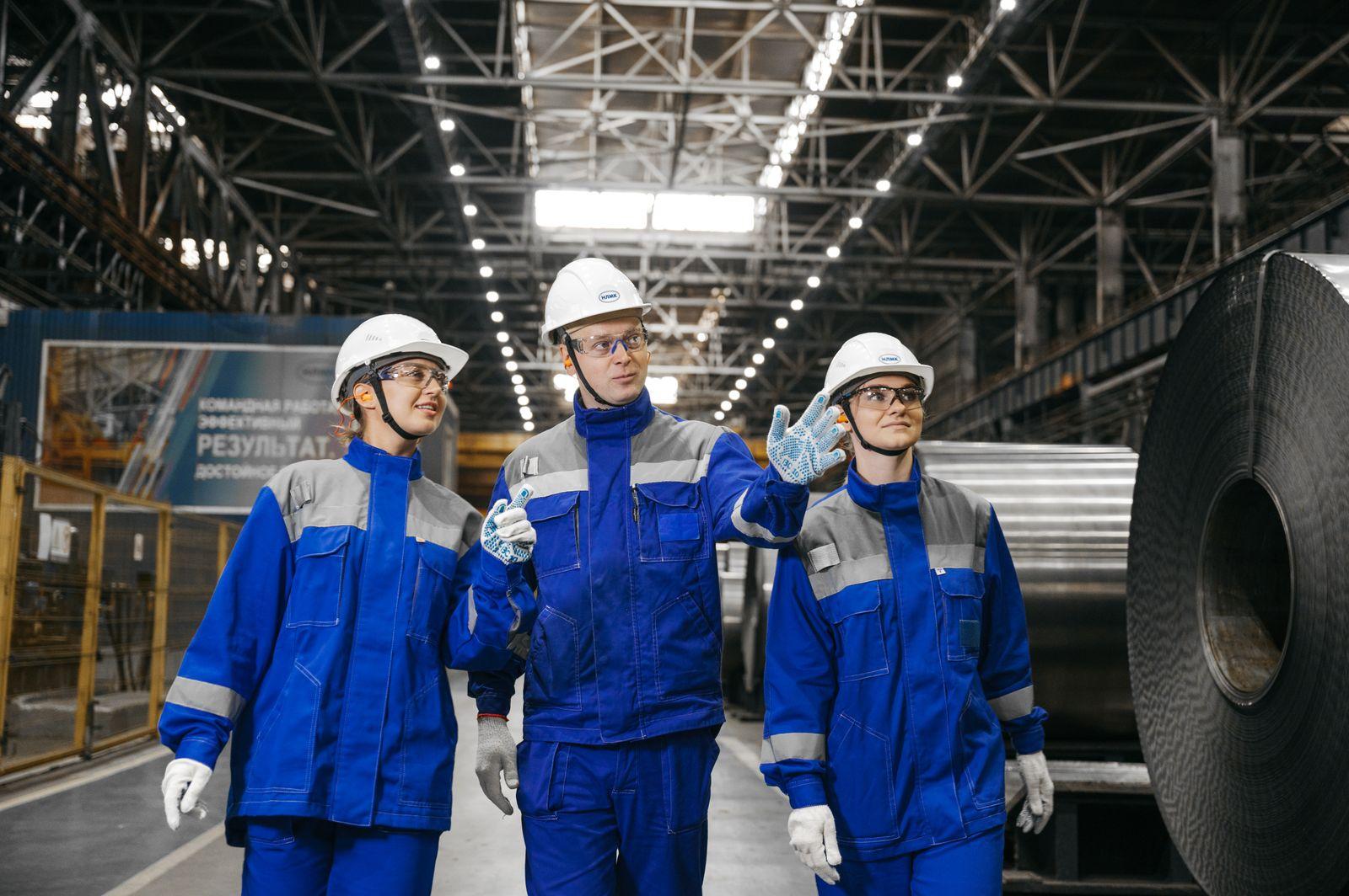 Industrial workers in safety gear at a plant